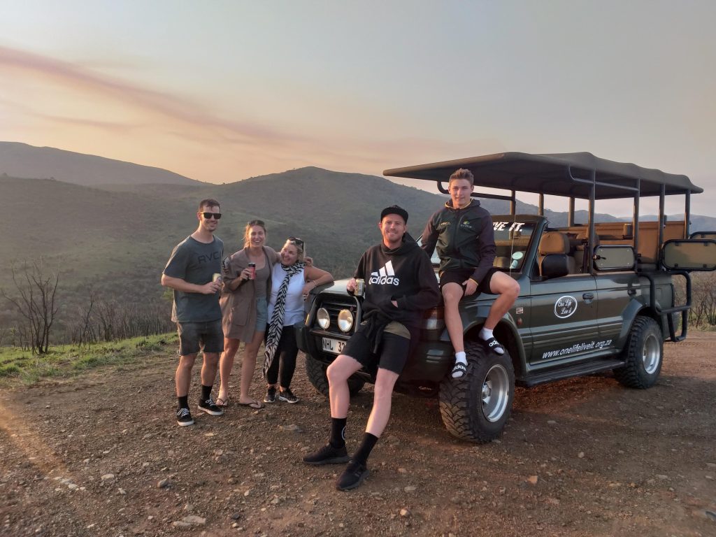 Happy guests relaxing with a Open Safari Vehicle